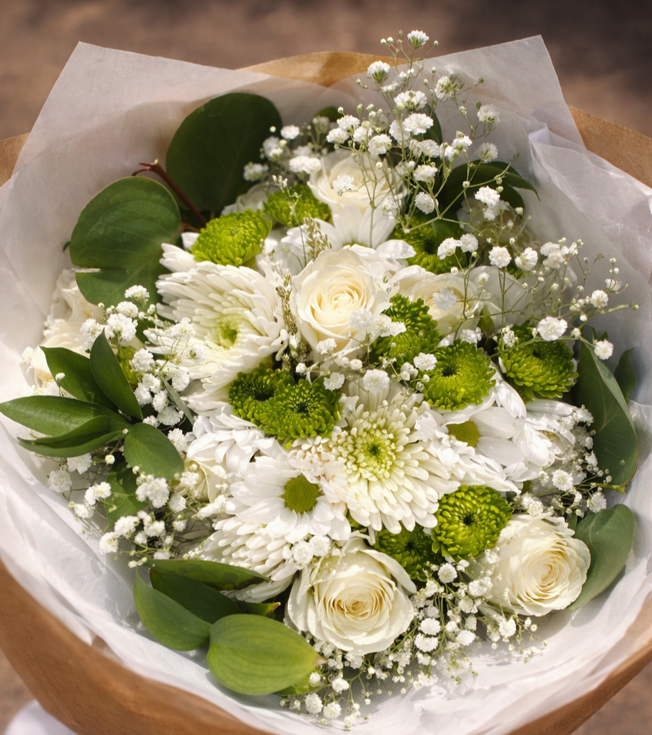 Bouquet of white and green flowers in a wooden basket
